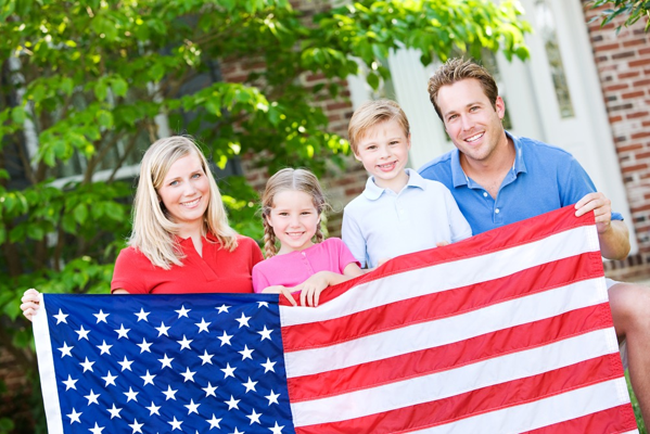 family holding up american flag